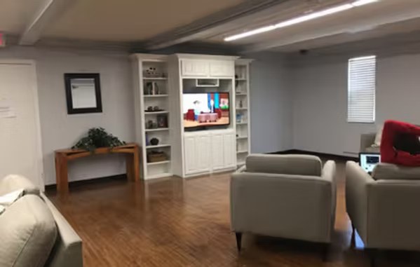 Residence hall common room with a television and seating